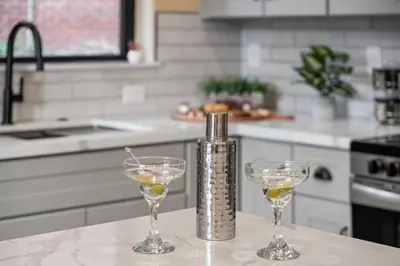 two wine glasses sitting on a counter in a kitchen at Luxury Living Modern Midtown Ensuite Baths Patio in Reno