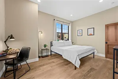 a bedroom with a bed and a desk and a desk at Luxury Living Modern Midtown Ensuite Baths Patio in Reno