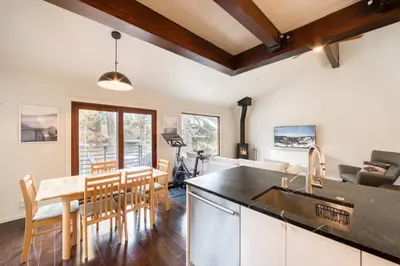 a kitchen and dining room with a sink and a table at Valley View Townhome # 10 at Palisades by Tahoe Getaways - Shuttle & Walk to the Village! in Olympic Valley