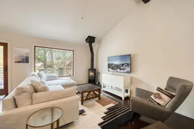 a living room with a couch and a table at Valley View Townhome # 10 at Palisades by Tahoe Getaways - Shuttle & Walk to the Village! in Olympic Valley