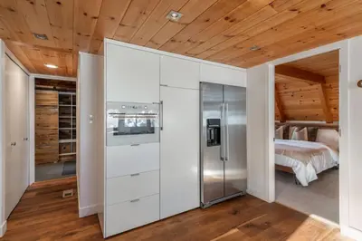 a bedroom with white cabinets and a bed in a room at Mountain Modern The Tahoe A-Frame w Private Pier in Homewood