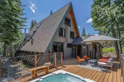 a house with a swimming pool on a wooden deck at Mountain Modern The Tahoe A-Frame w Private Pier in Homewood