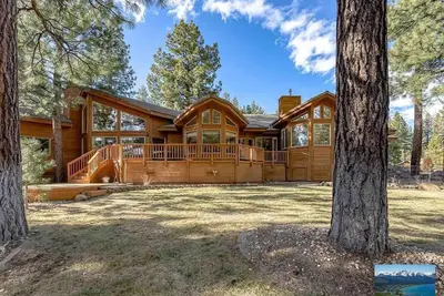 a large log home with a large deck at 6000 sqft Pine House with indoor swimming pool in Reno