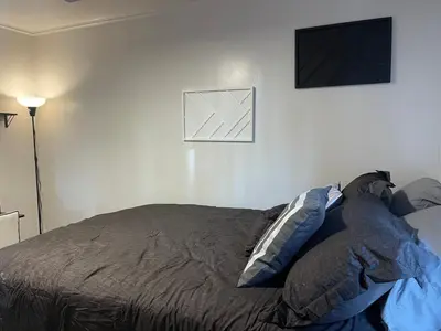 a bedroom with a bed and a television on the wall at A Little Bit Of Country in Visalia