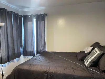 a bedroom with a bed with black curtains at A Little Bit Of Country in Visalia