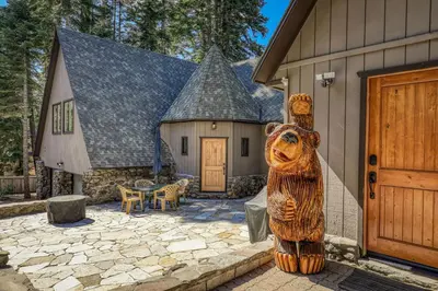 a wooden bear statue in front of a house at Tahoe Dreamer by Tahoe Getaways - Pet Friendly 4 BR Gated Home w Fenced Yard, Game Room & Walk to Lake! in Carnelian Bay