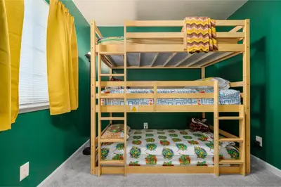 two bunk beds in a room with green walls at Immersive Stranger Things Experience in Clovis