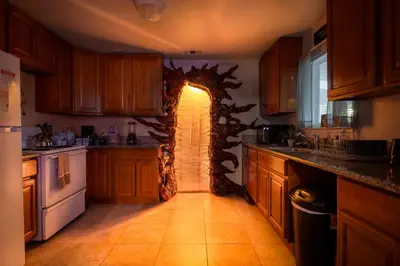 a kitchen with an archway in the middle of it at Immersive Stranger Things Experience in Clovis
