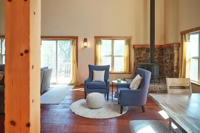 a living room with blue chairs and a fireplace at Rare Deluxe Family Cabin - Yosemite & Bass Lake in Bass Lake Annex