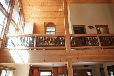 a large room with wooden ceilings and windows at Rare Deluxe Family Cabin - Yosemite & Bass Lake in Bass Lake Annex