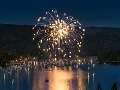a fireworks display over a body of water at night at Rare Deluxe Family Cabin - Yosemite & Bass Lake in Bass Lake Annex