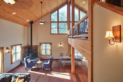 a large living room with a staircase in a house at Rare Deluxe Family Cabin - Yosemite & Bass Lake in Bass Lake Annex