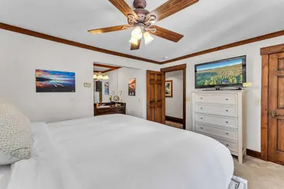 a bedroom with a white bed and a ceiling fan at 3-Level Incline Village Retreat with Fireplace in Incline Village