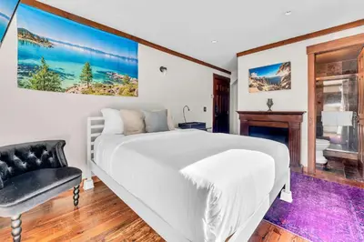 a bedroom with a large white bed and a chair at 3-Level Incline Village Retreat with Fireplace in Incline Village