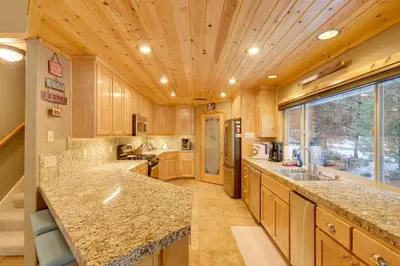 a large kitchen with wooden cabinets and a wooden ceiling at 5 Mi to Dodge Ridge Cabin in Strawberry in Strawberry