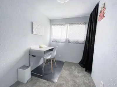 a small room with a white desk and window at Nifty Trailer With Spacious Parking in Visalia