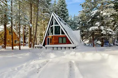 a small cabin in the snow in the woods at Elati Escape in South Lake Tahoe