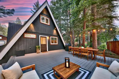 a house with a gambrel roof with a patio at Elati Escape in South Lake Tahoe