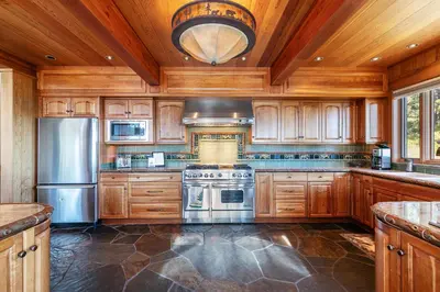 a kitchen with wooden cabinets and stainless steel appliances at Clouds Rest in Dollar Point By Tahoe Getaways - Lake views - Hot Tub & Game Room in Tahoe City