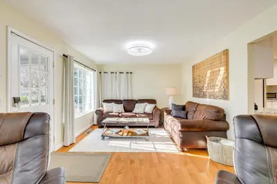 a living room with two couches and a table at Fire Pit and Grill Retreat Between Arnold and Murphys in Hathaway Pines