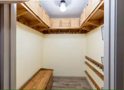 an empty room with wooden racks and stairs in a building at Cody's Comfy Cabin- Near Yosemite in Mariposa