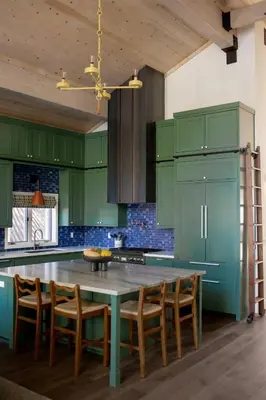 a kitchen with green cabinets and a table and chairs at Luxury Lakefront 5 Br Home Hot Tub Arcade in Truckee