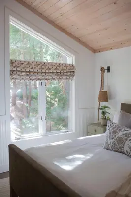 a bedroom with a large window and a bed at Luxury Lakefront 5 Br Home Hot Tub Arcade in Truckee