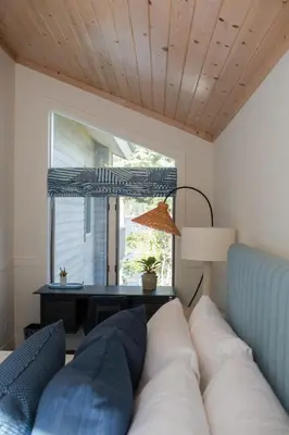 a living room with a couch and a window at Luxury Lakefront 5 Br Home Hot Tub Arcade in Truckee