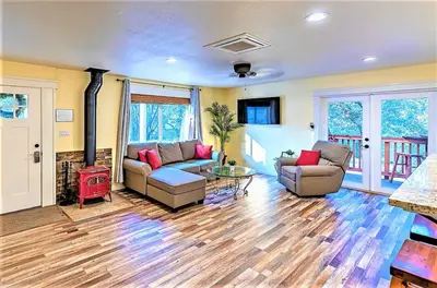 a living room with two couches and a table at Cody's Cozy Cottage-Near Yosemite in Mariposa