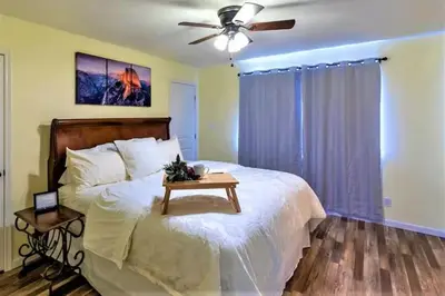 a bedroom with a bed with a table on it at Cody's Cozy Cottage-Near Yosemite in Mariposa