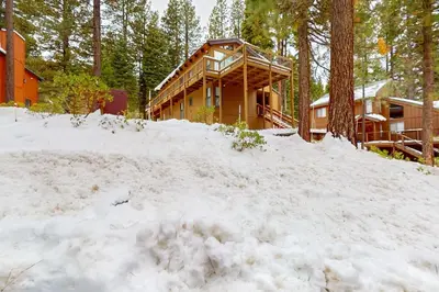 a log cabin in the woods in the snow at Wolf Tree Wonder in Truckee