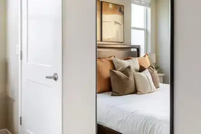 a bedroom with a bed with pillows on it at Amazing Water View with Jacuzzi & Sky Lounge in Sparks