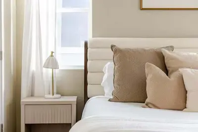 a bedroom with a bed with pillows and a window at Amazing Water View with Jacuzzi & Sky Lounge in Sparks