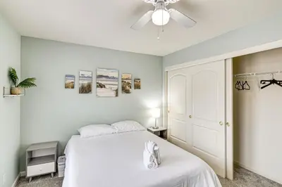 a bedroom with a white bed and a ceiling fan at Family Reno Home with Game Room! 28 Mi to Ski Resort in Reno