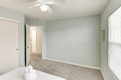 a white room with a ceiling fan and a window at Family Reno Home with Game Room! 28 Mi to Ski Resort in Reno