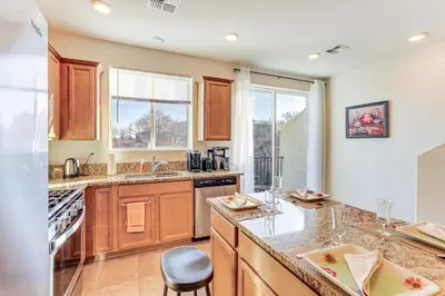 a kitchen with wooden cabinets and a counter top at 4 Mi to Dtwn Family-Friendly Townhome in Reno in Reno
