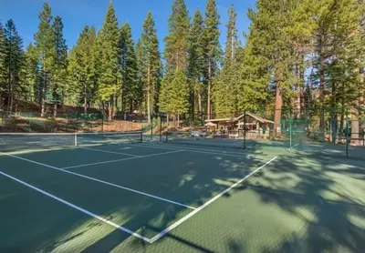 a tennis court with trees in the background at Timber Creek 309 condo in Truckee