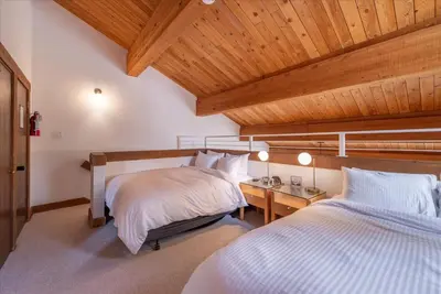 a bedroom with two beds and a wooden ceiling at Timber Creek 309 condo in Truckee