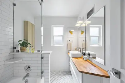 a white bathroom with two sinks and a mirror at Cozy Reno Midtown Retreat Fire Pit & Parking in Reno