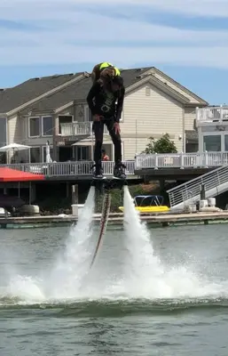 a man jumping into the water in the water at Marlin Cove Pet Friendly Waterfront Retreat in Discovery Bay