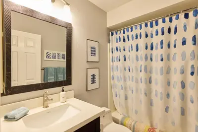 a bathroom with a sink and a mirror at Marlin Cove Pet Friendly Waterfront Retreat in Discovery Bay