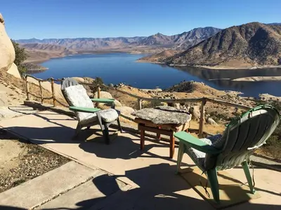 two chairs and a table on top of a view of a lake at Epic View Hot tub National forest in Wofford Heights
