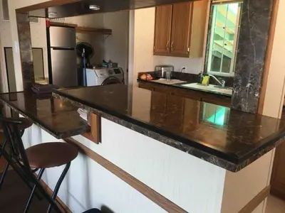 a kitchen with a black counter top in a room at Epic View Hot tub National forest in Wofford Heights