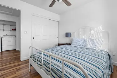 a white bedroom with a bed with blue and white pillows at 4 bedroom Home in Tracy 2 Minutes to Highway in Tracy