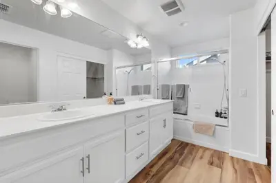 a white bathroom with a sink and a shower at 4 bedroom Home in Tracy 2 Minutes to Highway in Tracy