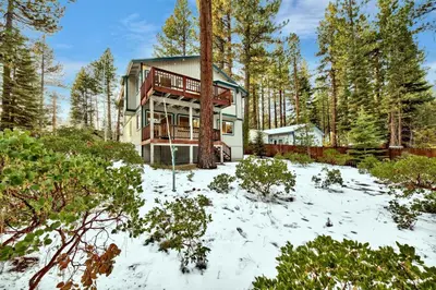 a house in the woods in the snow at Kamp Koyukon 1939K in South Lake Tahoe