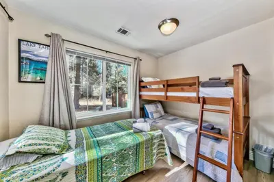 a bedroom with two bunk beds and a window at 1540TS Snowy Owl Cabin in South Lake Tahoe