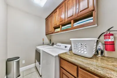 a small kitchen with a washer and dryer on a counter at 1540TS Snowy Owl Cabin in South Lake Tahoe