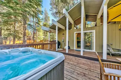 a hot tub on the deck of a house at 1540TS Snowy Owl Cabin in South Lake Tahoe