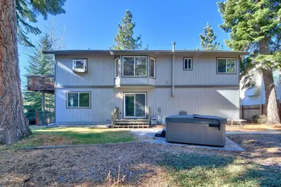 a large white house with a tree at 2272L The Lupine Lodge in South Lake Tahoe